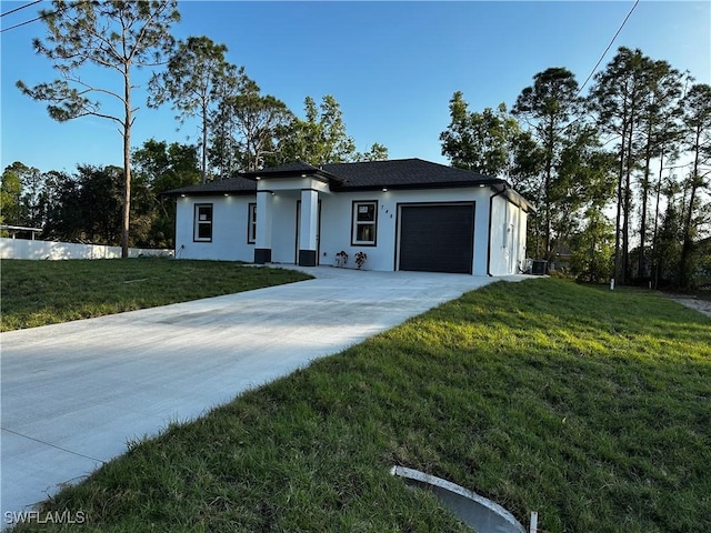 view of front of property with a garage and a front yard