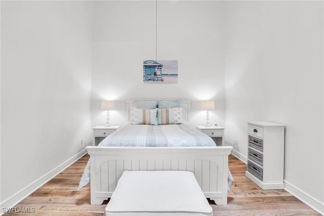 bedroom featuring light hardwood / wood-style flooring and radiator heating unit