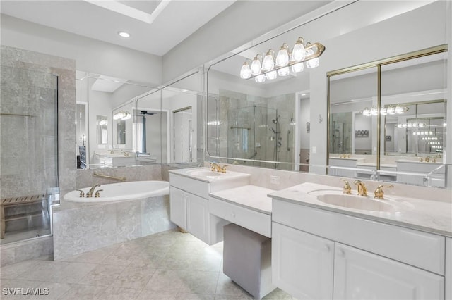 bathroom with tile patterned floors, vanity, and shower with separate bathtub