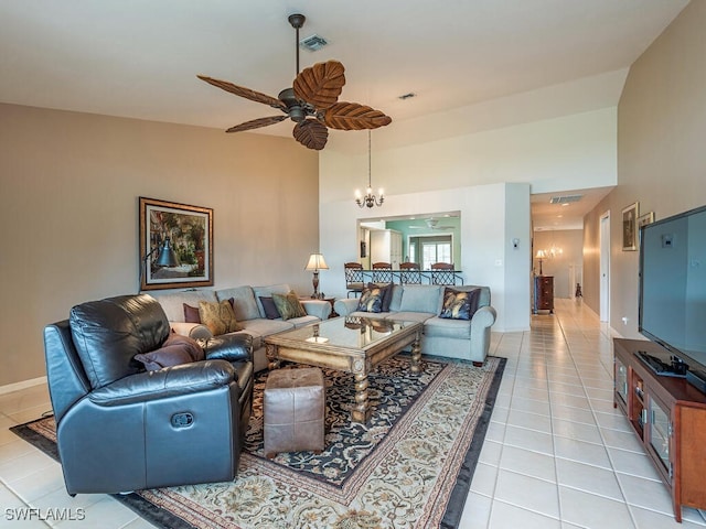 living room with ceiling fan with notable chandelier, lofted ceiling, and light tile patterned flooring