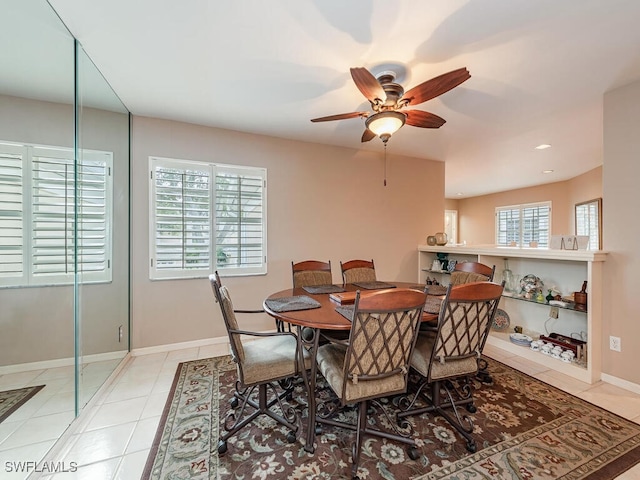 tiled dining area featuring ceiling fan