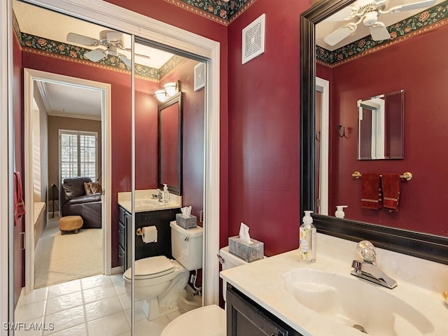 bathroom featuring ceiling fan, toilet, crown molding, and vanity