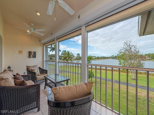 sunroom / solarium with ceiling fan and a water view