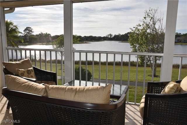 sunroom with a healthy amount of sunlight and a water view