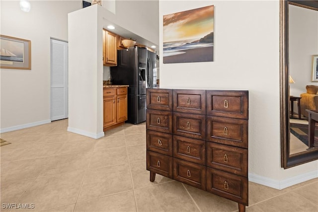 kitchen featuring stainless steel fridge with ice dispenser and light tile patterned floors