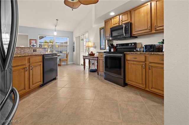 kitchen featuring dishwasher, dark stone counters, black range with electric stovetop, vaulted ceiling, and decorative light fixtures