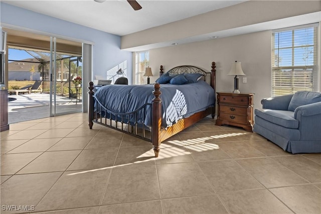 tiled bedroom with ceiling fan, access to exterior, and multiple windows