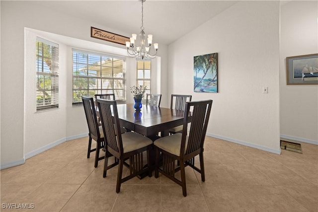 dining room with a notable chandelier, light tile patterned floors, and lofted ceiling