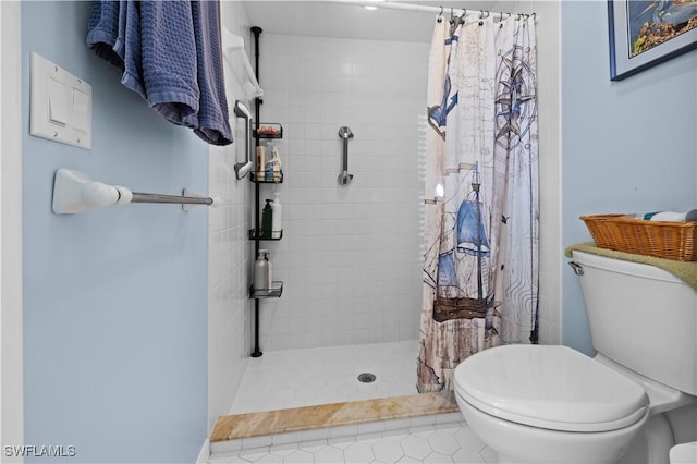 bathroom with tile patterned floors, a shower with curtain, and toilet