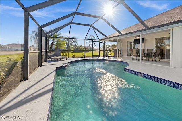 view of pool with a patio, ceiling fan, and a lanai