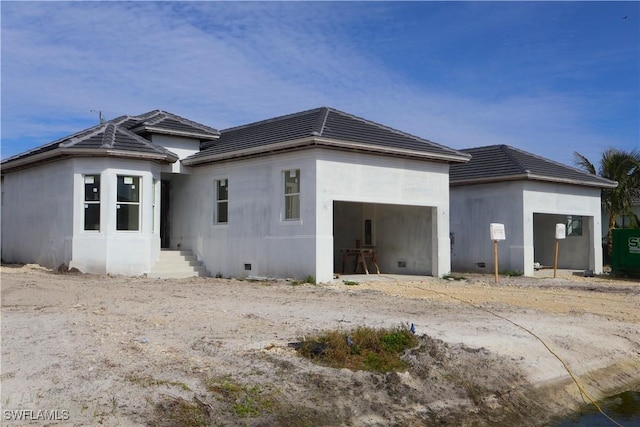 rear view of house featuring a garage