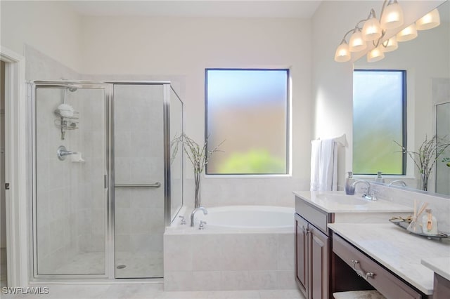 full bath with vanity, an inviting chandelier, a bath, and a stall shower