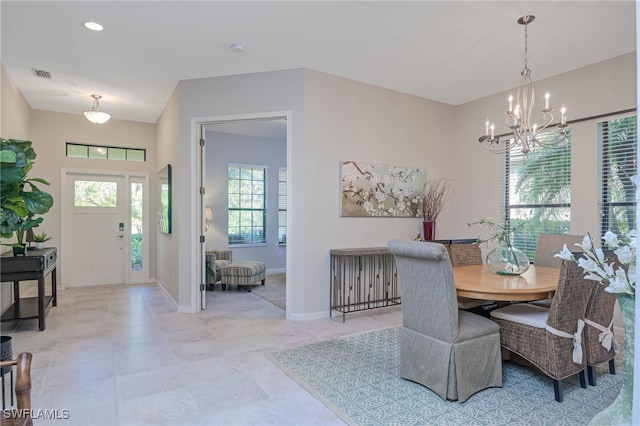 dining space with an inviting chandelier, light tile patterned floors, baseboards, and visible vents