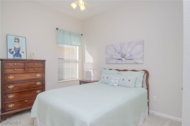 bedroom with light colored carpet and baseboards
