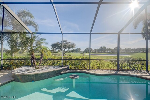 view of pool featuring glass enclosure