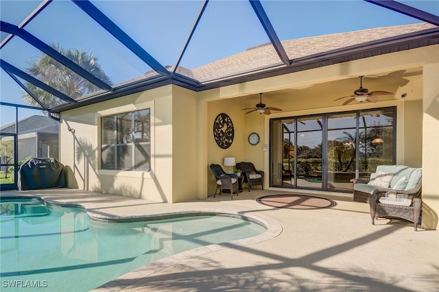 exterior space featuring glass enclosure, ceiling fan, and a patio area