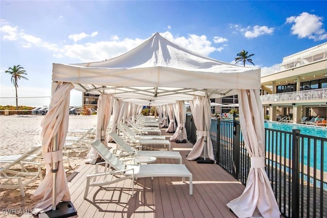 wooden deck with a community pool