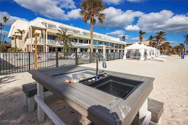 view of patio with a pool with hot tub, sink, and a gazebo