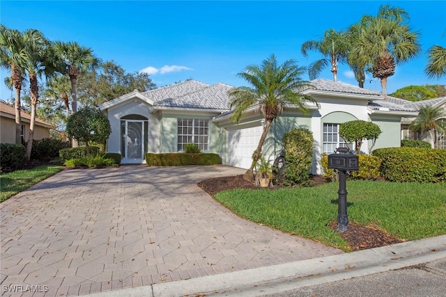 view of front facade with a garage and a front yard