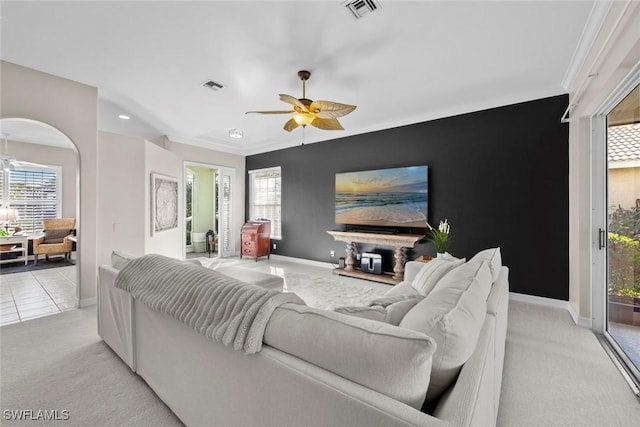 carpeted living room with ceiling fan