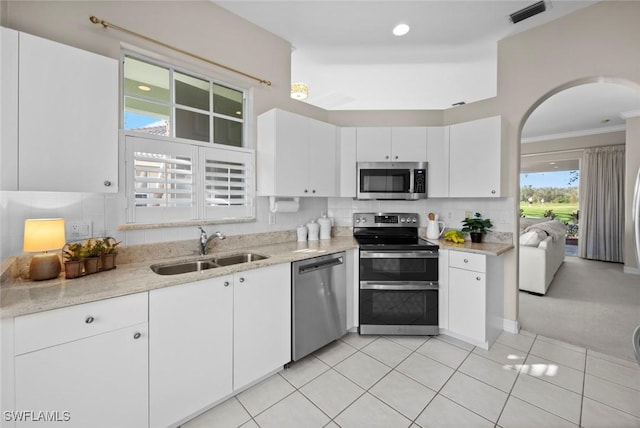 kitchen with stainless steel appliances, white cabinetry, and sink