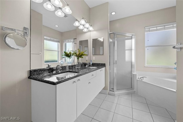 bathroom featuring tile patterned floors, vanity, and shower with separate bathtub