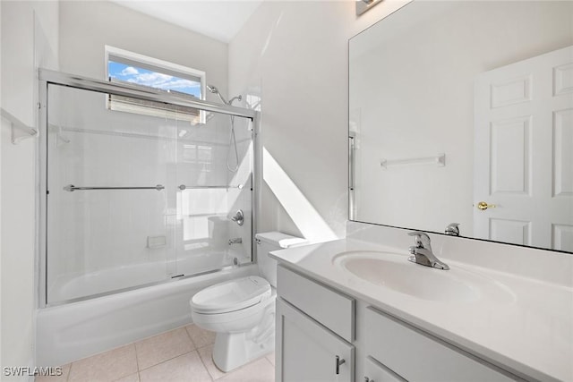 full bathroom with tile patterned flooring, vanity, toilet, and shower / bath combination with glass door