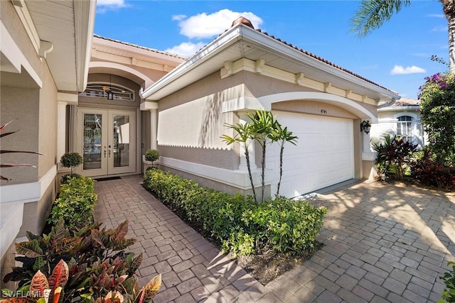 doorway to property featuring french doors and a garage