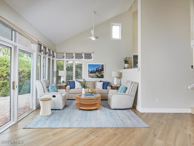 living room featuring light hardwood / wood-style floors, high vaulted ceiling, and ceiling fan