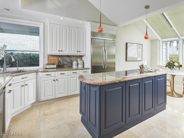 kitchen with decorative backsplash, stainless steel appliances, vaulted ceiling, white cabinets, and hanging light fixtures