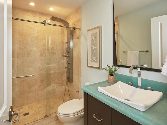 bathroom featuring vanity, toilet, and walk in shower