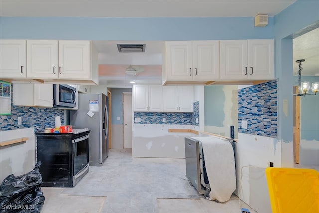 kitchen featuring white cabinetry, an inviting chandelier, decorative light fixtures, and appliances with stainless steel finishes