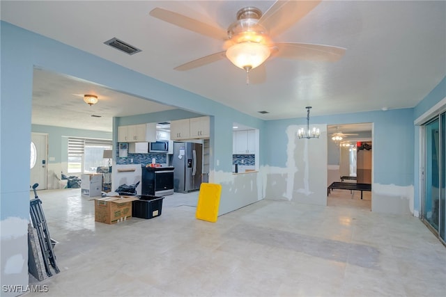 living room featuring ceiling fan with notable chandelier