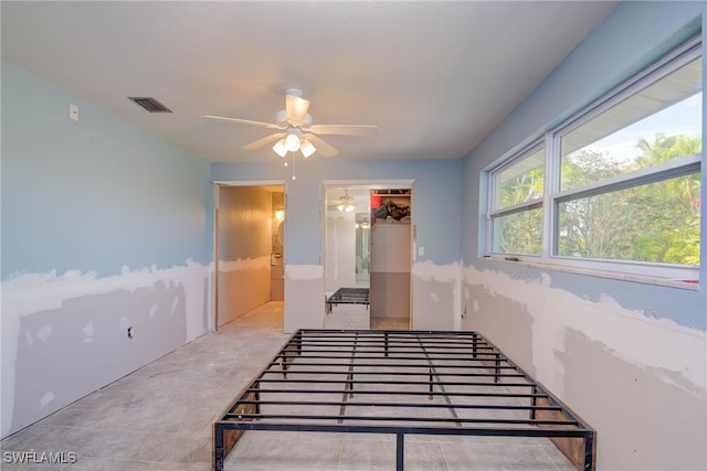 stairs featuring ceiling fan