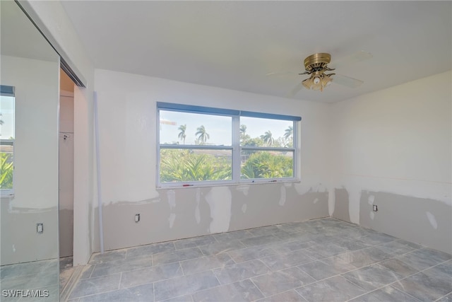 unfurnished room with ceiling fan