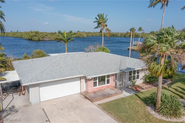 ranch-style house featuring a water view and a garage