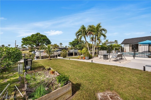 view of yard with a fenced in pool and a patio