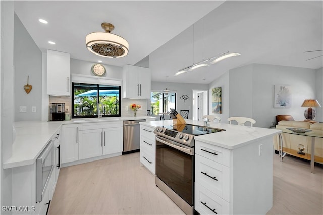 kitchen with white cabinets and appliances with stainless steel finishes