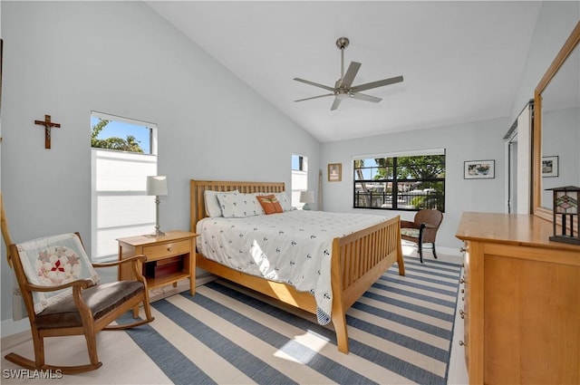 bedroom featuring ceiling fan and high vaulted ceiling