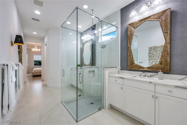 ensuite bathroom with a wealth of natural light, a shower stall, and connected bathroom