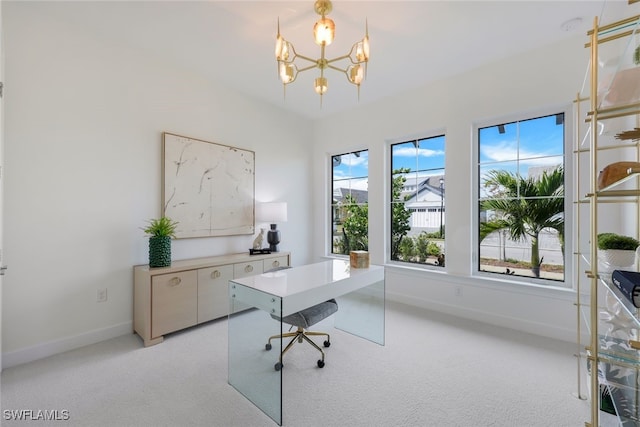 office space featuring light carpet, baseboards, and an inviting chandelier