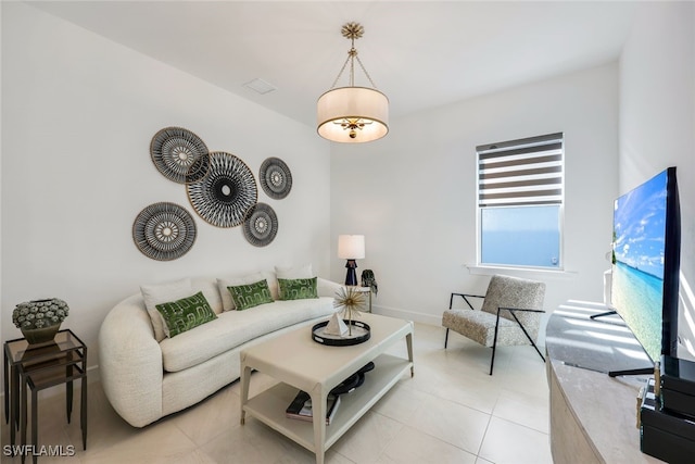 living room with light tile patterned flooring and baseboards