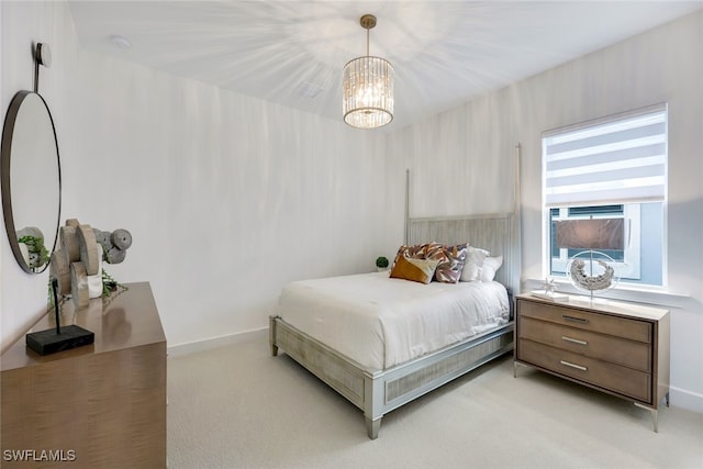 bedroom with light carpet and baseboards