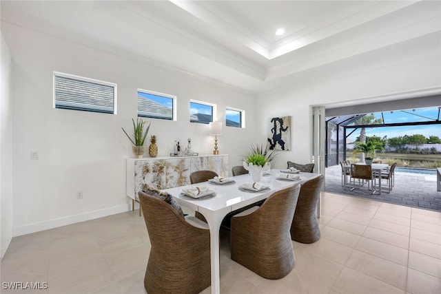 dining room featuring recessed lighting, a raised ceiling, a sunroom, light tile patterned flooring, and baseboards