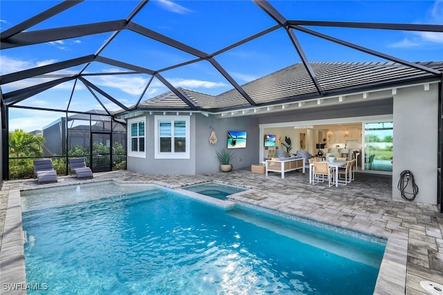 rear view of house with a patio, a pool with connected hot tub, a tiled roof, stucco siding, and outdoor dining space