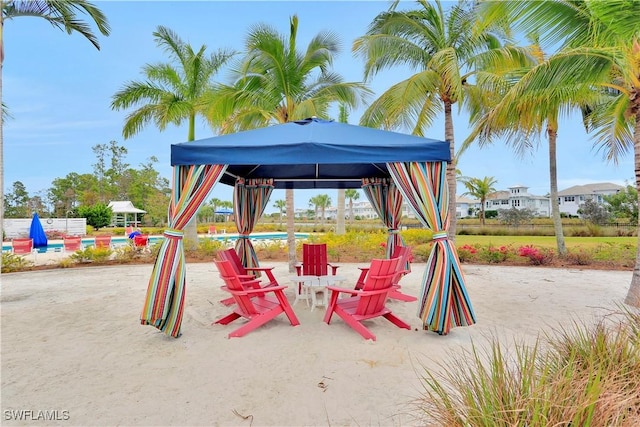 view of playground with a community pool, a patio, and a gazebo