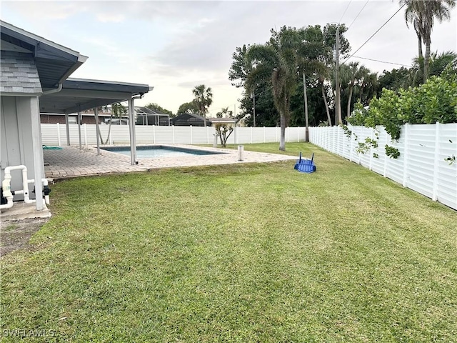 view of yard featuring a fenced in pool and a patio area