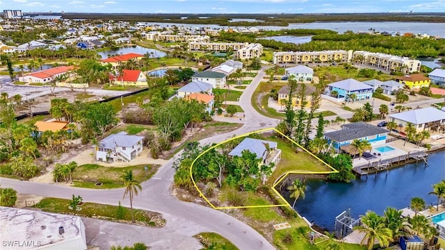 bird's eye view featuring a residential view and a water view