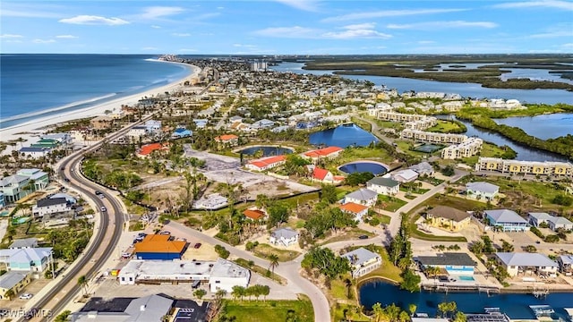 drone / aerial view with a water view, a residential view, and a view of the beach