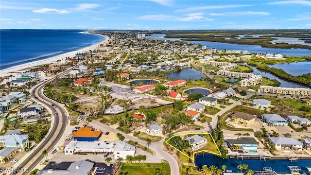 aerial view with a water view, a view of the beach, and a residential view